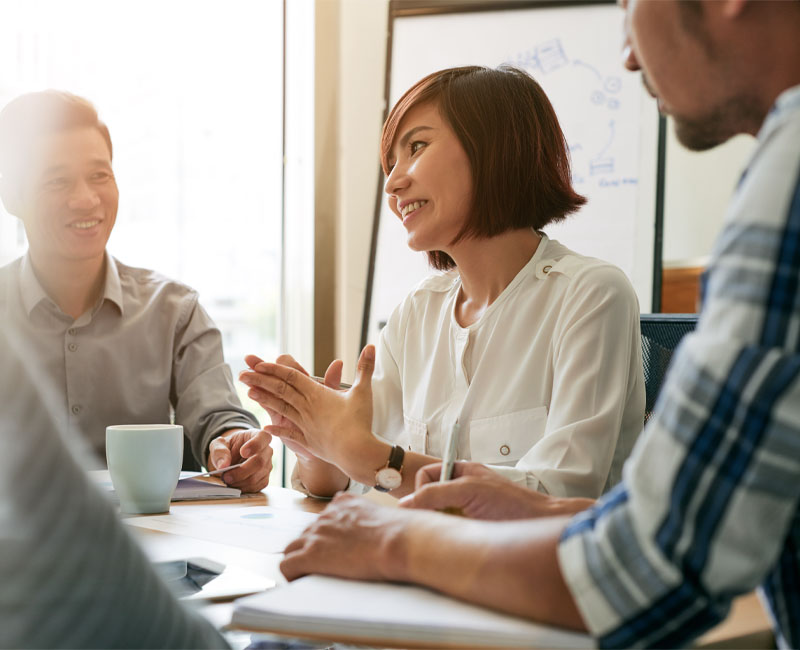 Coworkers discussing their employee benefits program